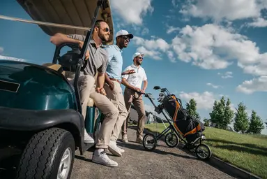 group of friends by a golf cart