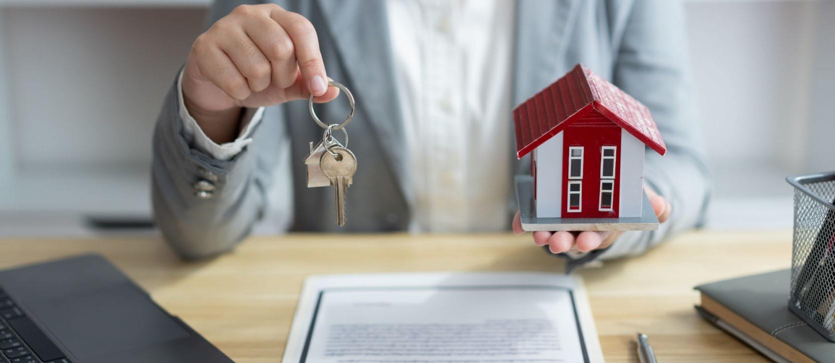 Person handing over the keys of a new home and contract